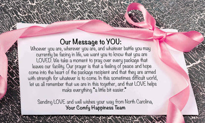 Message card with pink ribbon, expressing love and support from Your Comfy Happiness Team.